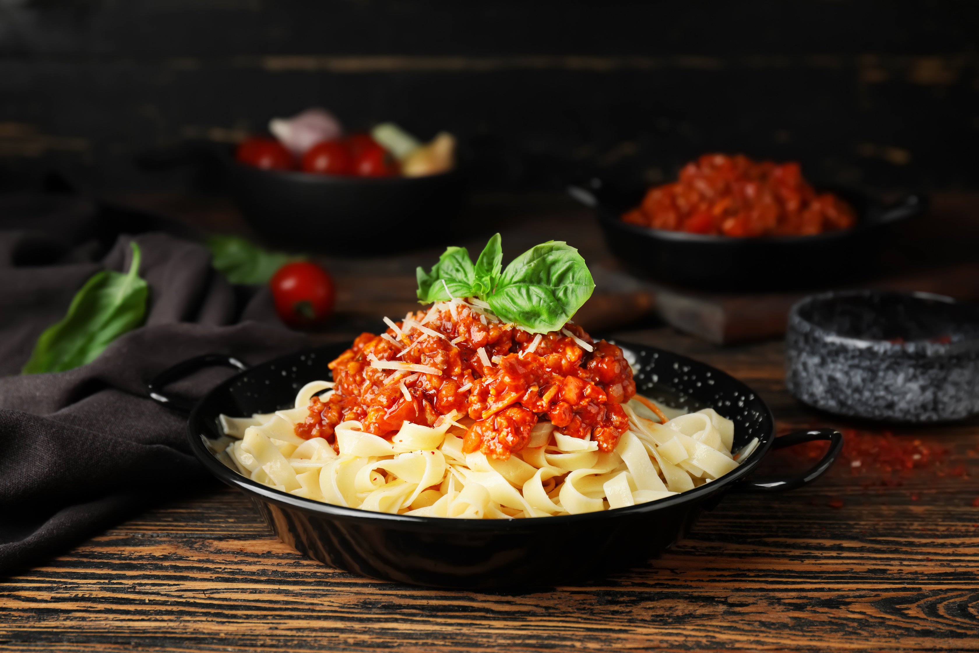 Frying Pan with Tasty Pasta Bolognese on Table